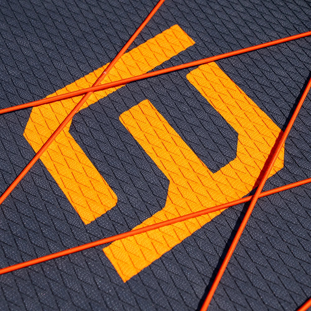 Close-up of a textured surface with an orange logo and orange lines.