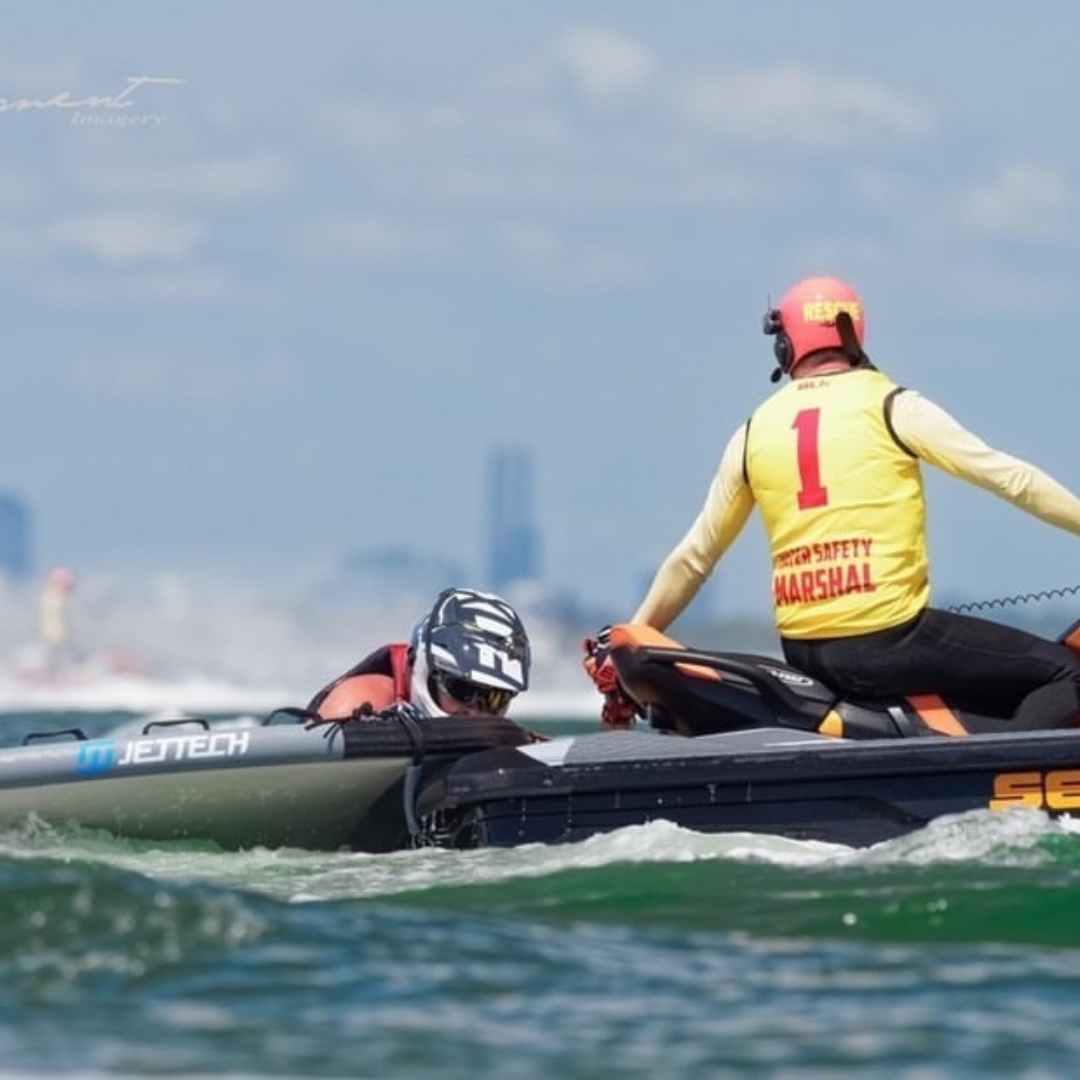 man climbing onto jet ski