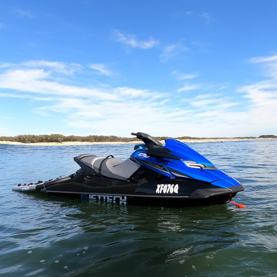 Jet ski anchored behind surf break