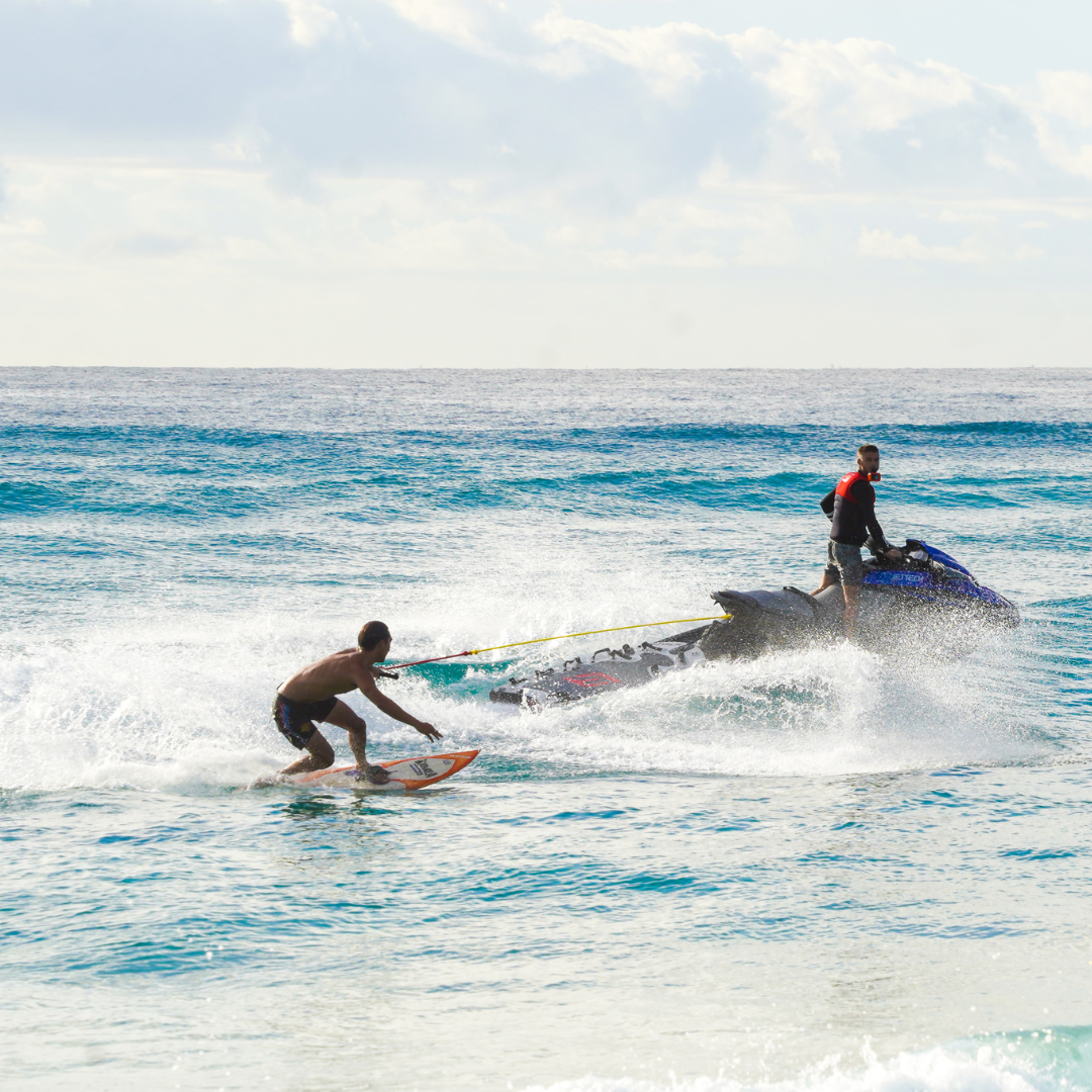 man holding onto rope surfing