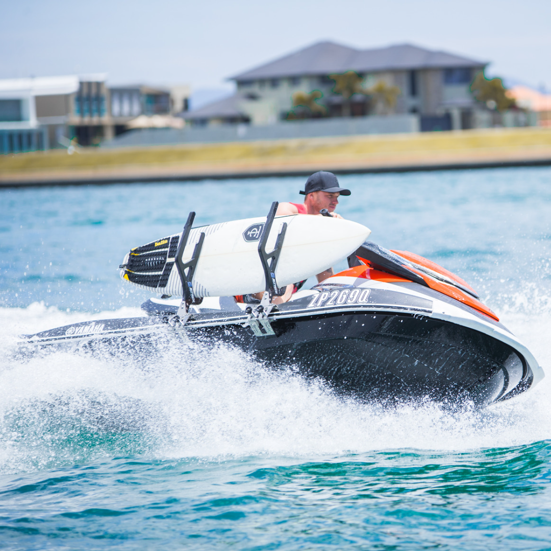 Man driving jet ski with surfboard rack