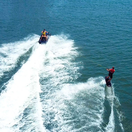man wake boarding behind jet ski