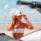 girl wearing hat on beach