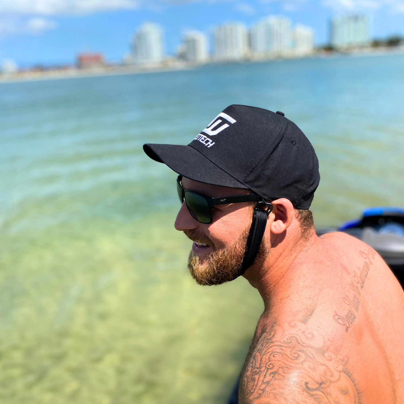 man wearing sun glasses and hat on water