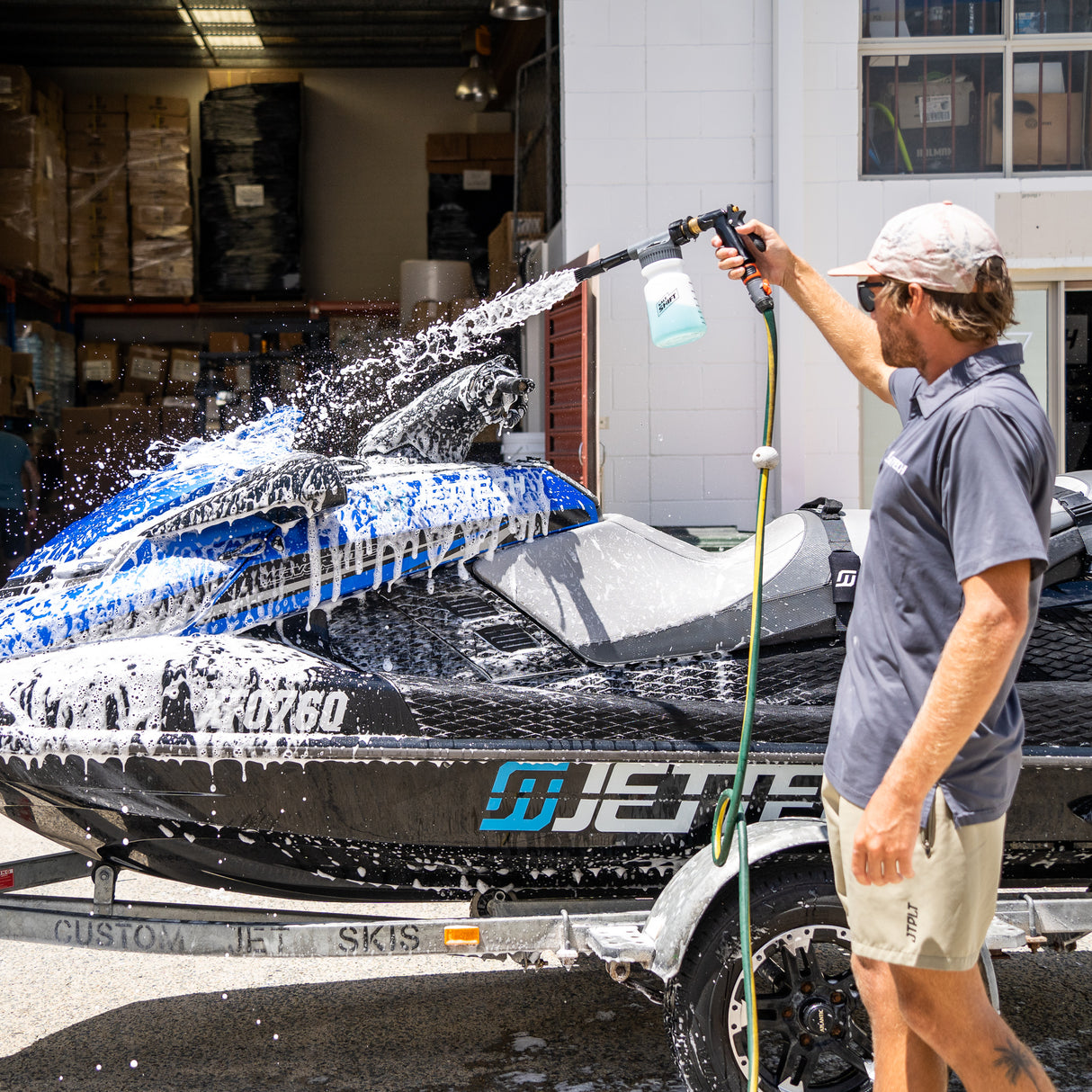 man washing jet ski