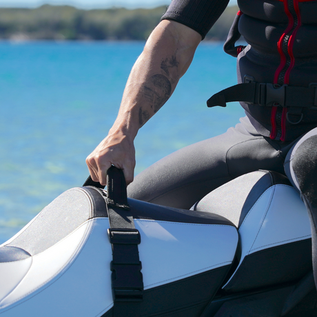 man holding onto handle on jet ski