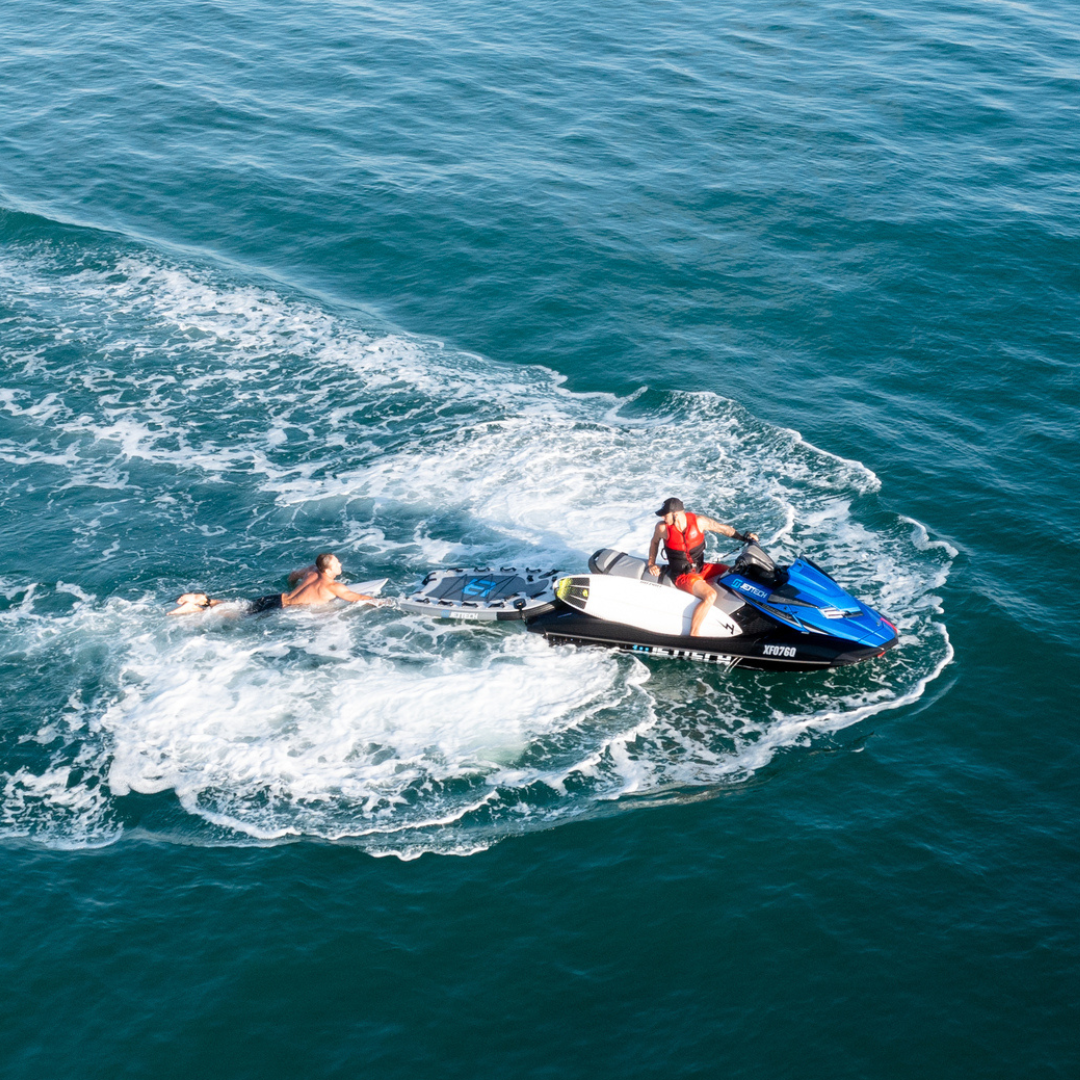 man getting picked up by jet ski