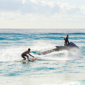 man holding onto rope surfing 